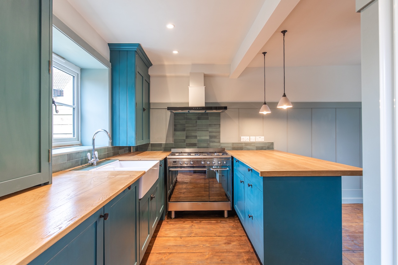 Modern Kitchen Interior - Teal Cabinets with Wooden Countertops